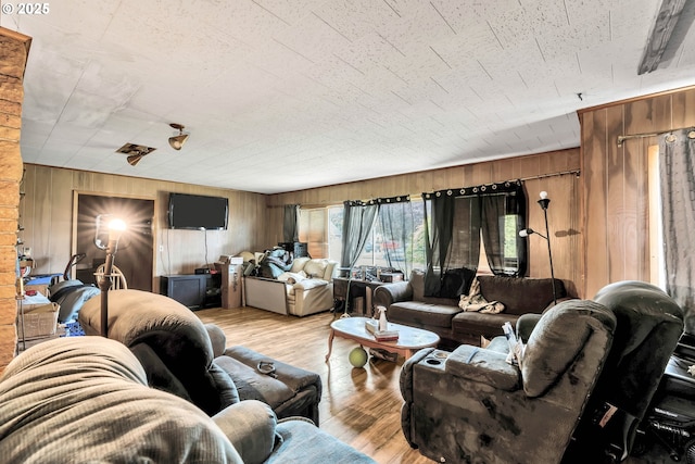 living room featuring wood walls and wood finished floors
