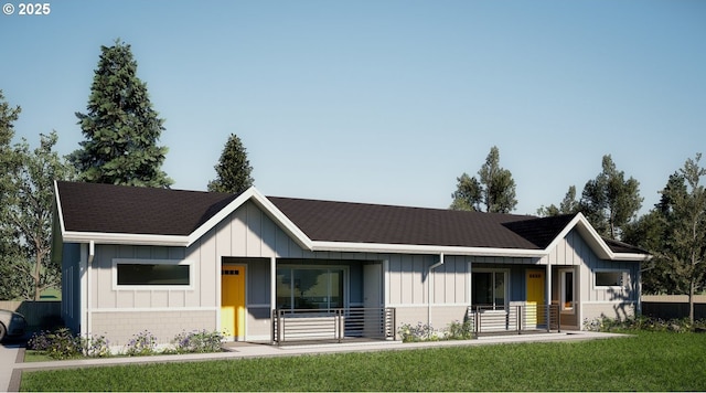 3035 Hyacinth St Unit B, Eugene, OR 97404 - view of front of home with covered porch, board and batten siding, a front lawn, and a shingled roof