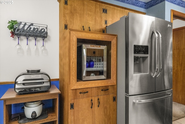 kitchen with stainless steel fridge and brown cabinetry
