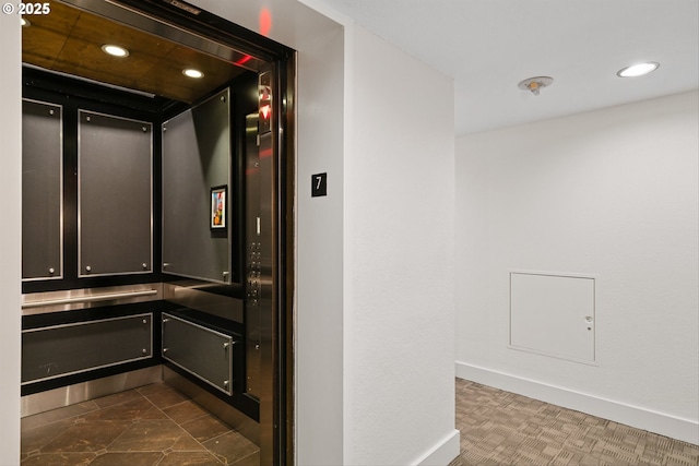bathroom with recessed lighting, baseboards, and elevator