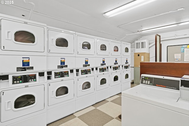 shared laundry area featuring light floors, stacked washer and clothes dryer, and washer and dryer