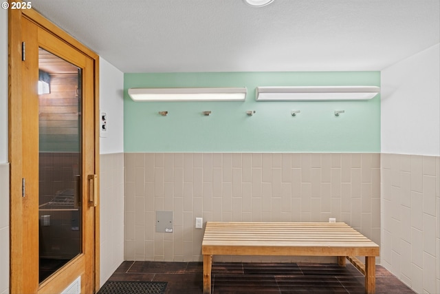 bathroom featuring tile walls and a wainscoted wall