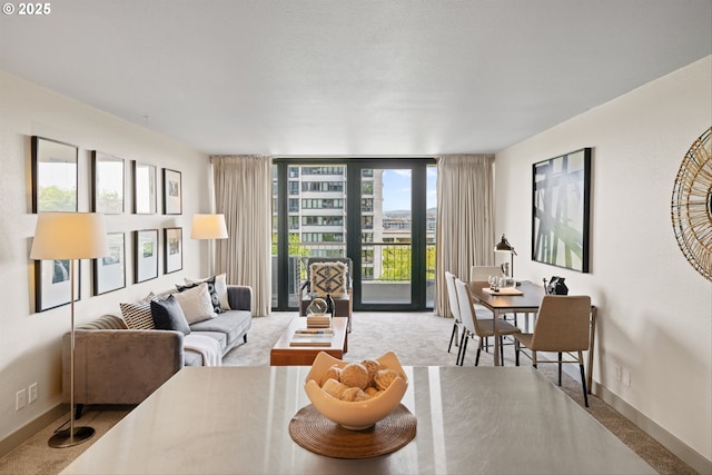 living area featuring expansive windows, carpet flooring, and baseboards