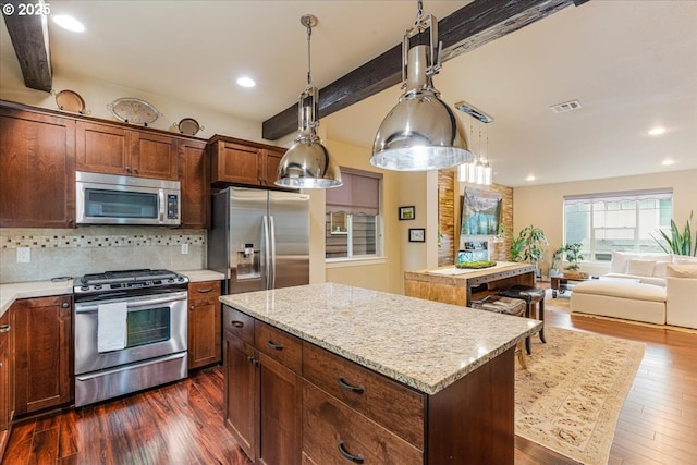 14215 SW Burlwood Ln, Beaverton, OR 97005 - kitchen featuring visible vents, a kitchen island, dark wood-style flooring, stainless steel appliances, and decorative backsplash