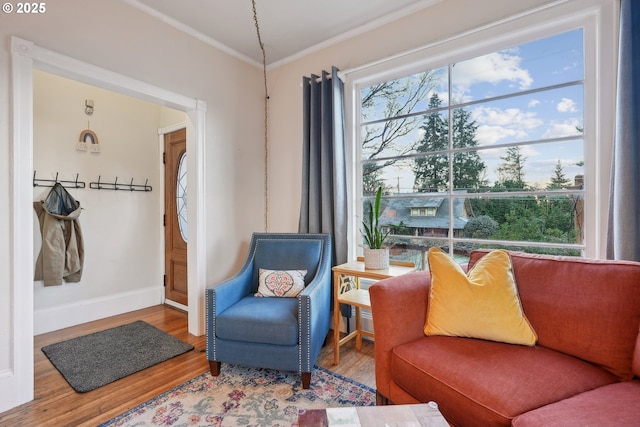 living room with hardwood / wood-style flooring and ornamental molding