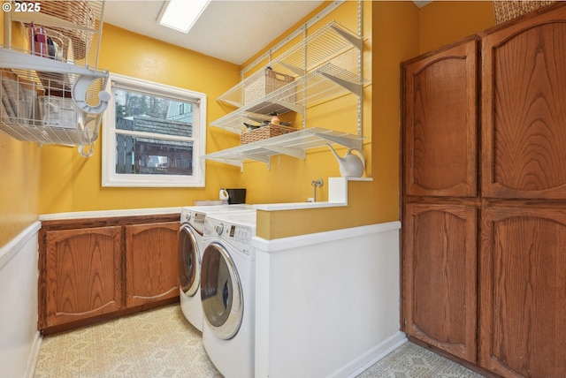 laundry area with cabinets and washing machine and clothes dryer