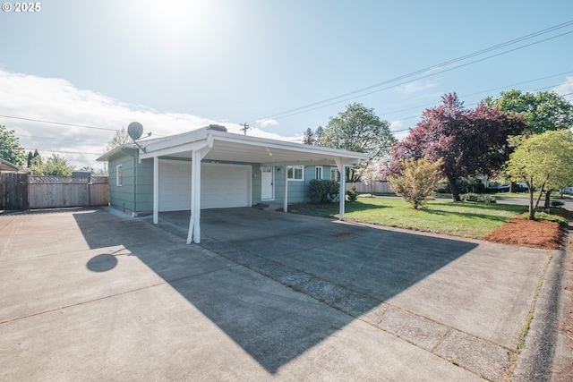 exterior space with a garage, fence, a front yard, and concrete driveway
