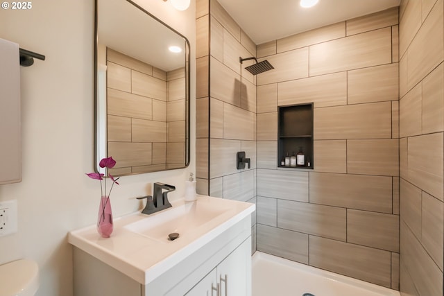 full bath with toilet, a tile shower, recessed lighting, and vanity