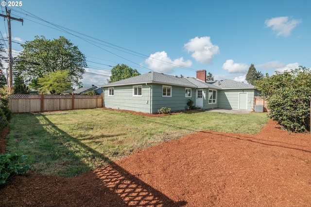back of property featuring a chimney, fence, central AC unit, roof with shingles, and a lawn