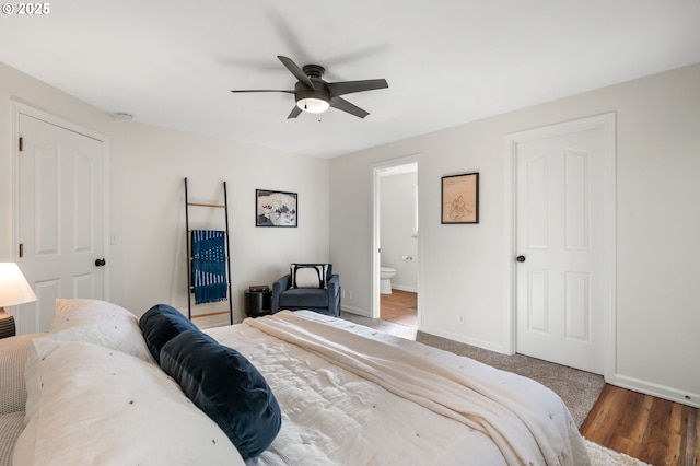 bedroom featuring ceiling fan, baseboards, wood finished floors, and ensuite bathroom