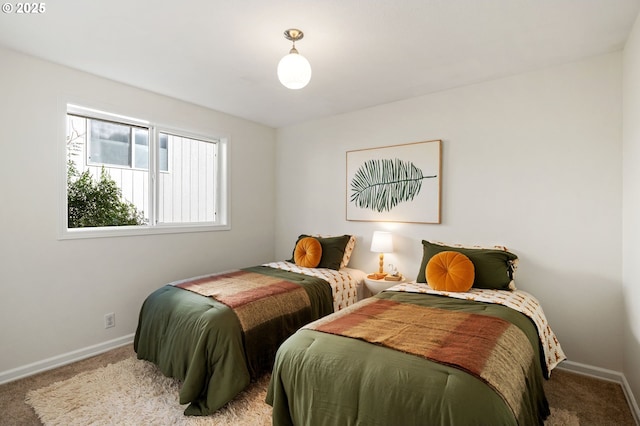 bedroom featuring baseboards and carpet