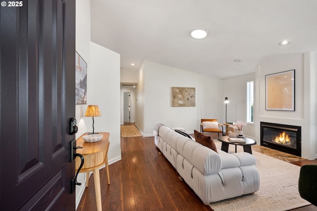 living room with a glass covered fireplace, baseboards, dark wood-style floors, and recessed lighting