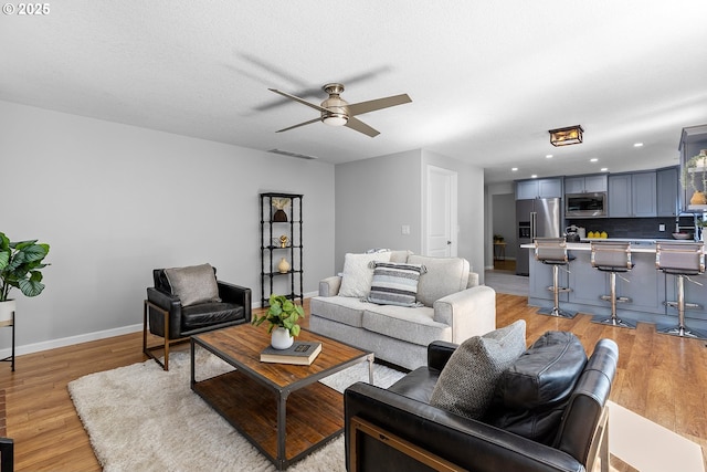 2111 NE 149th Ave, Vancouver, WA 98684 - living room featuring a ceiling fan, light wood-style floors, baseboards, and recessed lighting