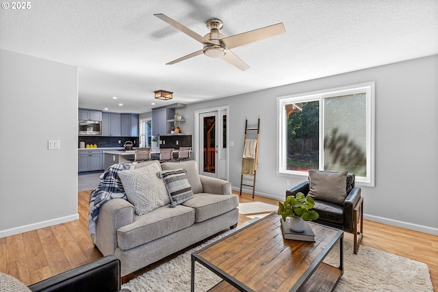 2111 NE 149th Ave, Vancouver, WA 98684 - living area featuring healthy amount of natural light, light wood-style floors, baseboards, recessed lighting, and a textured ceiling