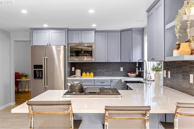 2111 NE 149th Ave, Vancouver, WA 98684 - kitchen with appliances with stainless steel finishes, gray cabinets, a sink, recessed lighting, and light stone countertops