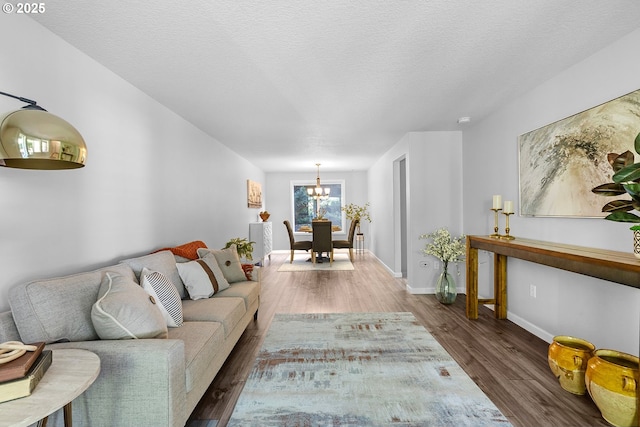 2111 NE 149th Ave, Vancouver, WA 98684 - living area with wood finished floors, a chandelier, baseboards, and a textured ceiling