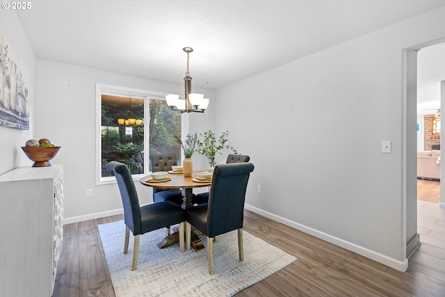 2111 NE 149th Ave, Vancouver, WA 98684 - dining space featuring a chandelier, wood finished floors, plenty of natural light, and baseboards