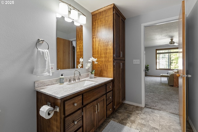 2111 NE 149th Ave, Vancouver, WA 98684 - bathroom featuring vanity, ceiling fan, baseboards, and stone finish flooring