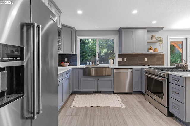 2111 NE 149th Ave, Vancouver, WA 98684 - kitchen featuring premium appliances, a sink, gray cabinets, recessed lighting, and a textured ceiling
