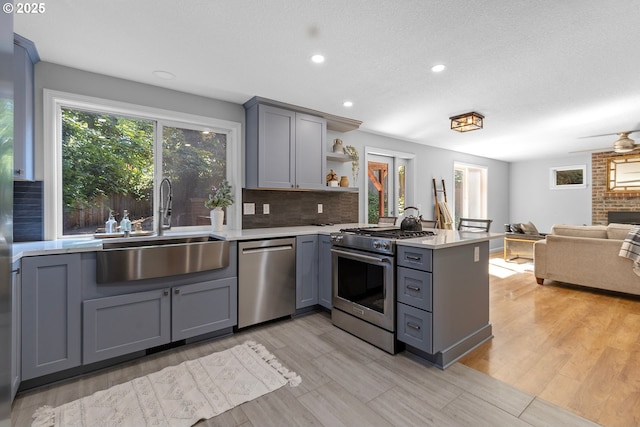 2111 NE 149th Ave, Vancouver, WA 98684 - kitchen featuring stainless steel appliances, gray cabinets, a sink, a peninsula, and open shelves