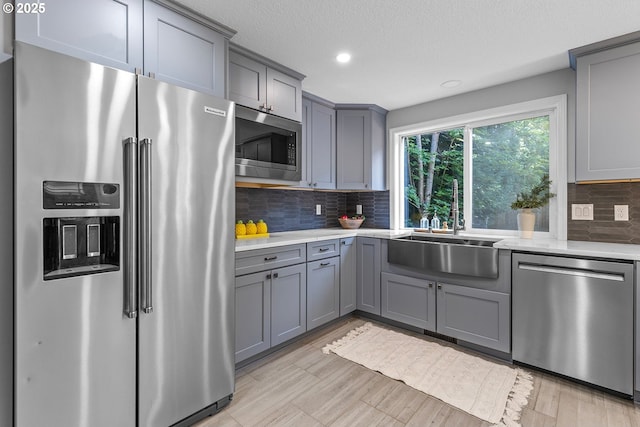 2111 NE 149th Ave, Vancouver, WA 98684 - kitchen with appliances with stainless steel finishes, a sink, gray cabinetry, recessed lighting, and decorative backsplash