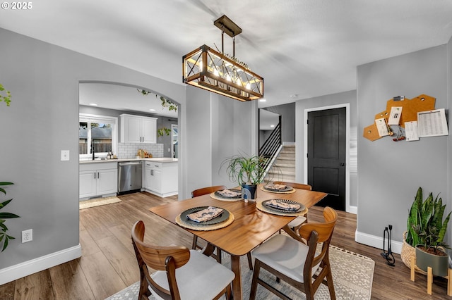 10417 NE 86th Ave, Vancouver, WA 98662 - dining room with wood finished floors, arched walkways, and stairway