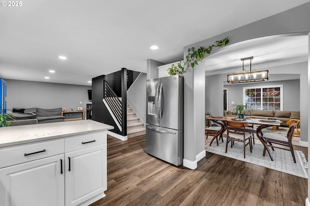 10417 NE 86th Ave, Vancouver, WA 98662 - kitchen featuring stainless steel fridge with ice dispenser, dark wood finished floors, open floor plan, arched walkways, and white cabinetry