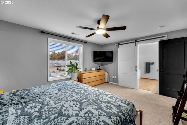 10417 NE 86th Ave, Vancouver, WA 98662 - bedroom featuring a barn door, light carpet, and a ceiling fan