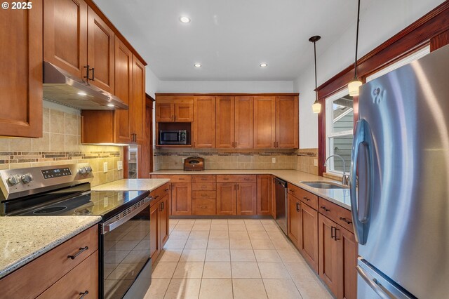2309 7th St, Tillamook, OR 97141 - kitchen featuring stainless steel appliances, under cabinet range hood, a sink, brown cabinets, and recessed lighting