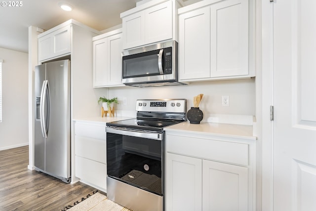 kitchen featuring light wood finished floors, white cabinetry, stainless steel appliances, and light countertops