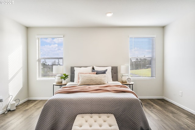 bedroom with baseboards and wood finished floors