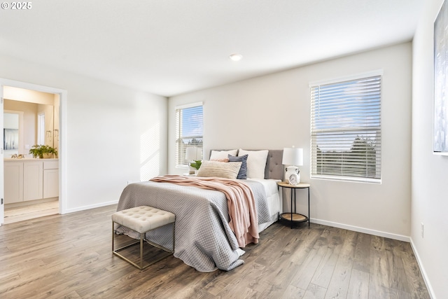 bedroom with wood finished floors and baseboards