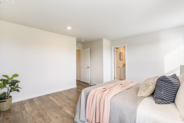 bedroom with recessed lighting, ensuite bathroom, baseboards, and wood finished floors