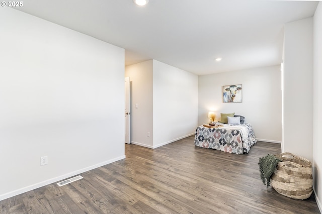 unfurnished bedroom featuring baseboards, visible vents, wood finished floors, and recessed lighting