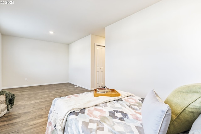 bedroom featuring baseboards and wood finished floors