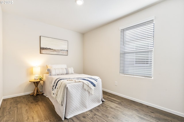 bedroom with wood finished floors and baseboards