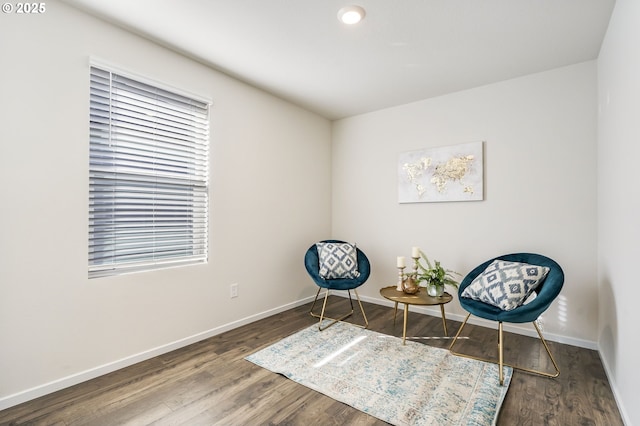 living area featuring baseboards and wood finished floors