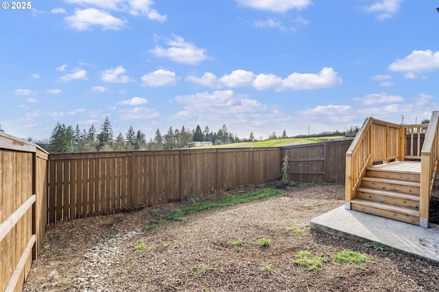 view of yard with a fenced backyard and a deck