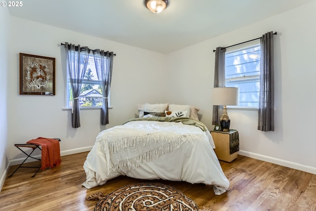 6540 SE 88th Ave, Portland, OR 97266 - bedroom featuring multiple windows, baseboards, and wood finished floors
