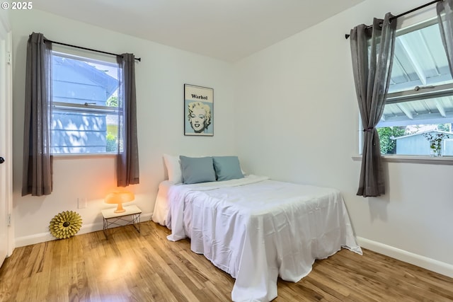 6540 SE 88th Ave, Portland, OR 97266 - bedroom featuring wood finished floors, multiple windows, and baseboards