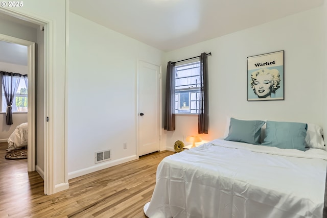 6540 SE 88th Ave, Portland, OR 97266 - bedroom featuring light wood finished floors, multiple windows, and baseboards