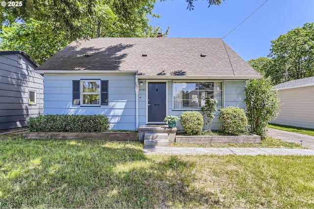 6540 SE 88th Ave, Portland, OR 97266 - view of front facade featuring roof with shingles, a front yard, and a chimney