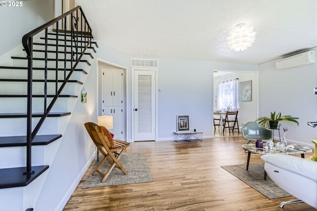 6540 SE 88th Ave, Portland, OR 97266 - living room with a wall unit AC, stairs, wood finished floors, and baseboards