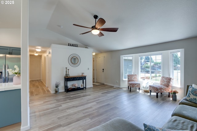 1185 Shady Ln, Keizer, OR 97303 - living room featuring vaulted ceiling, a ceiling fan, and light wood-style flooring