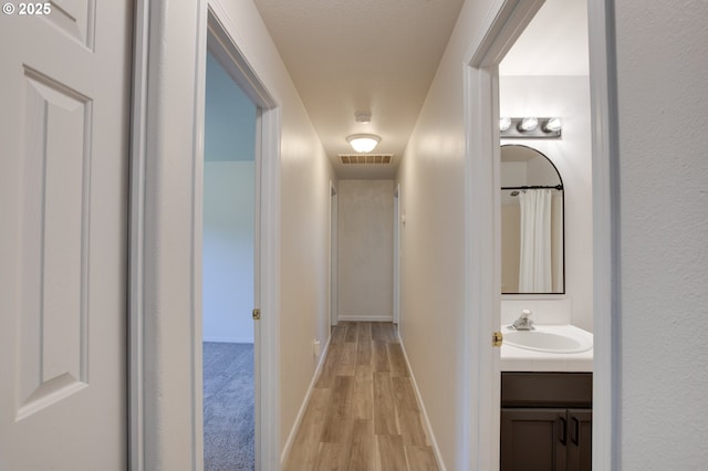 1185 Shady Ln, Keizer, OR 97303 - corridor featuring a sink and light wood-type flooring
