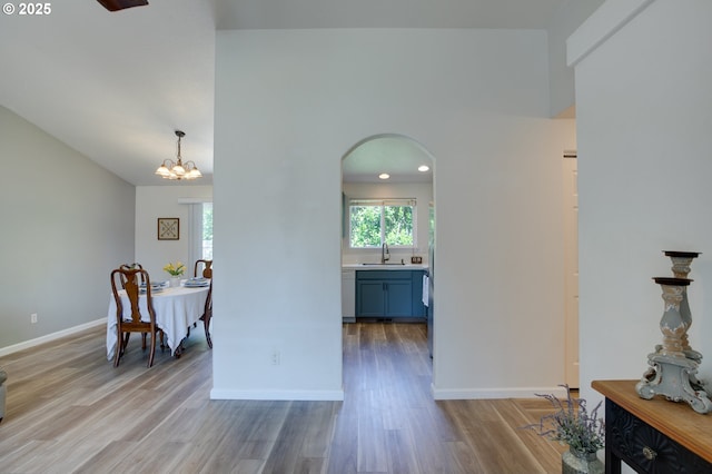 1185 Shady Ln, Keizer, OR 97303 - interior space featuring arched walkways, light wood-style floors, and a chandelier