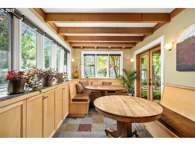 sunroom with french doors, plenty of natural light, and beamed ceiling