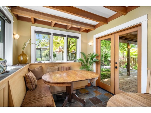 sunroom featuring french doors and beam ceiling