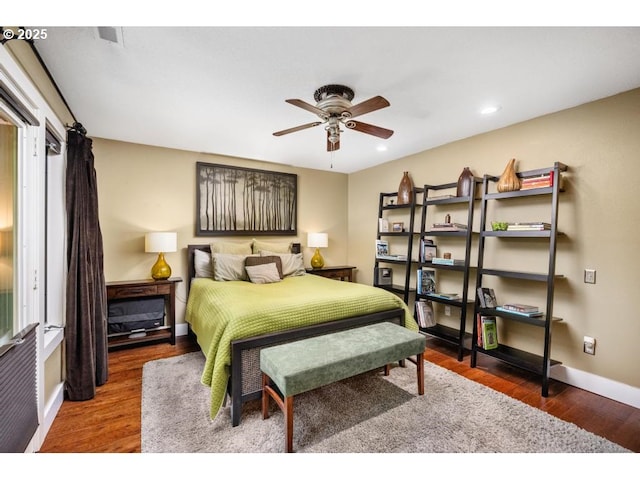 bedroom featuring baseboards, recessed lighting, and wood finished floors