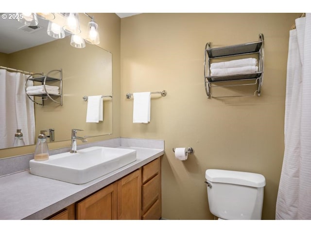 full bath with toilet, visible vents, and vanity